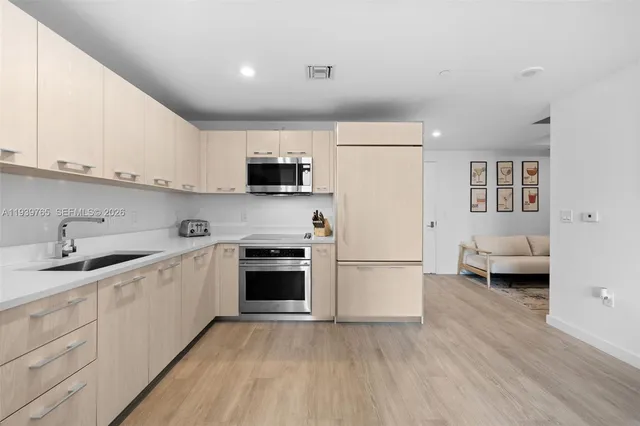 a kitchen with a sink a stove and cabinets