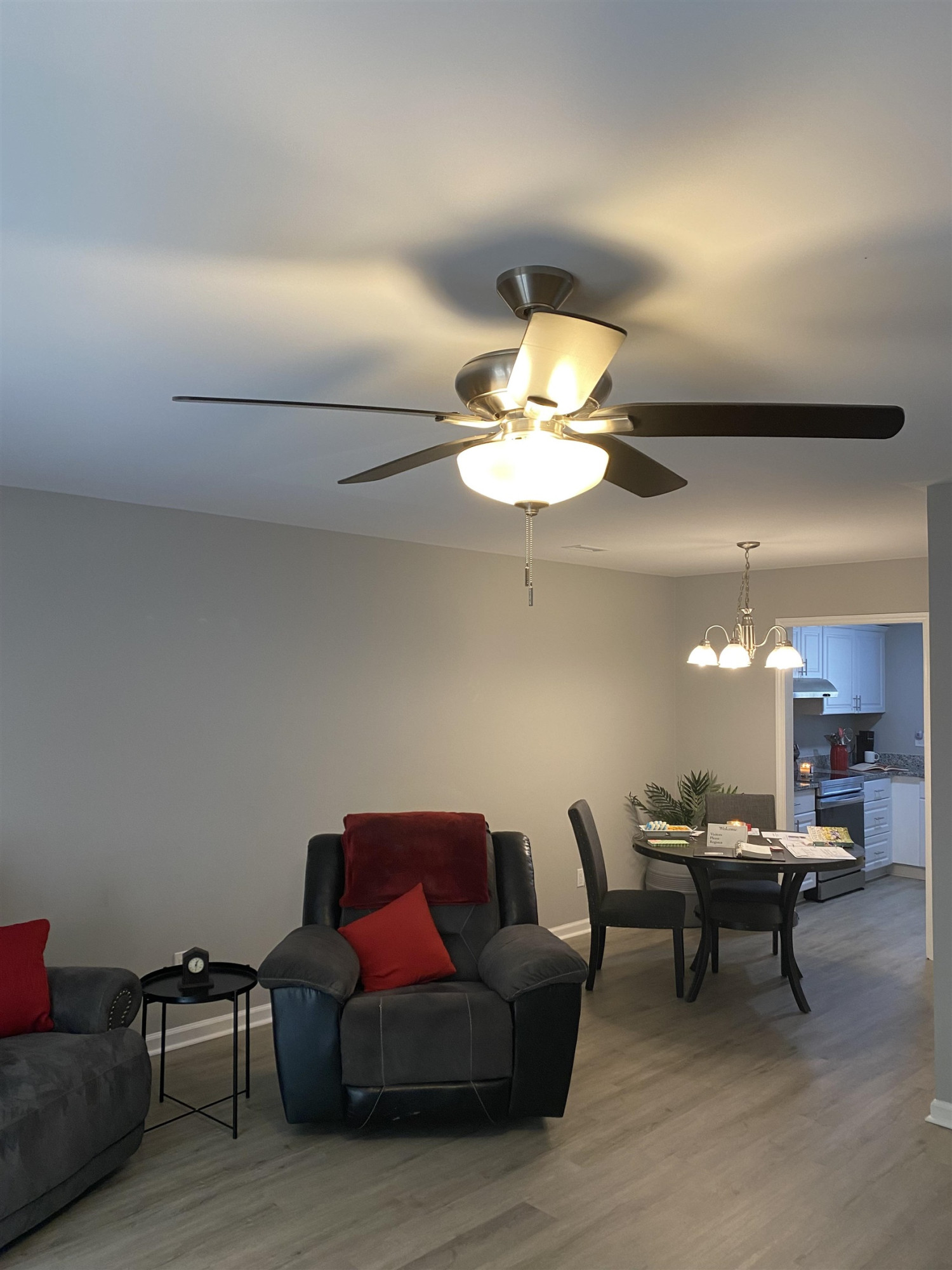 643 Springview Trail Garner, NC 27529 - Photo 14 of 34 a living room with furniture a chandelier and a dining table with a kitchen