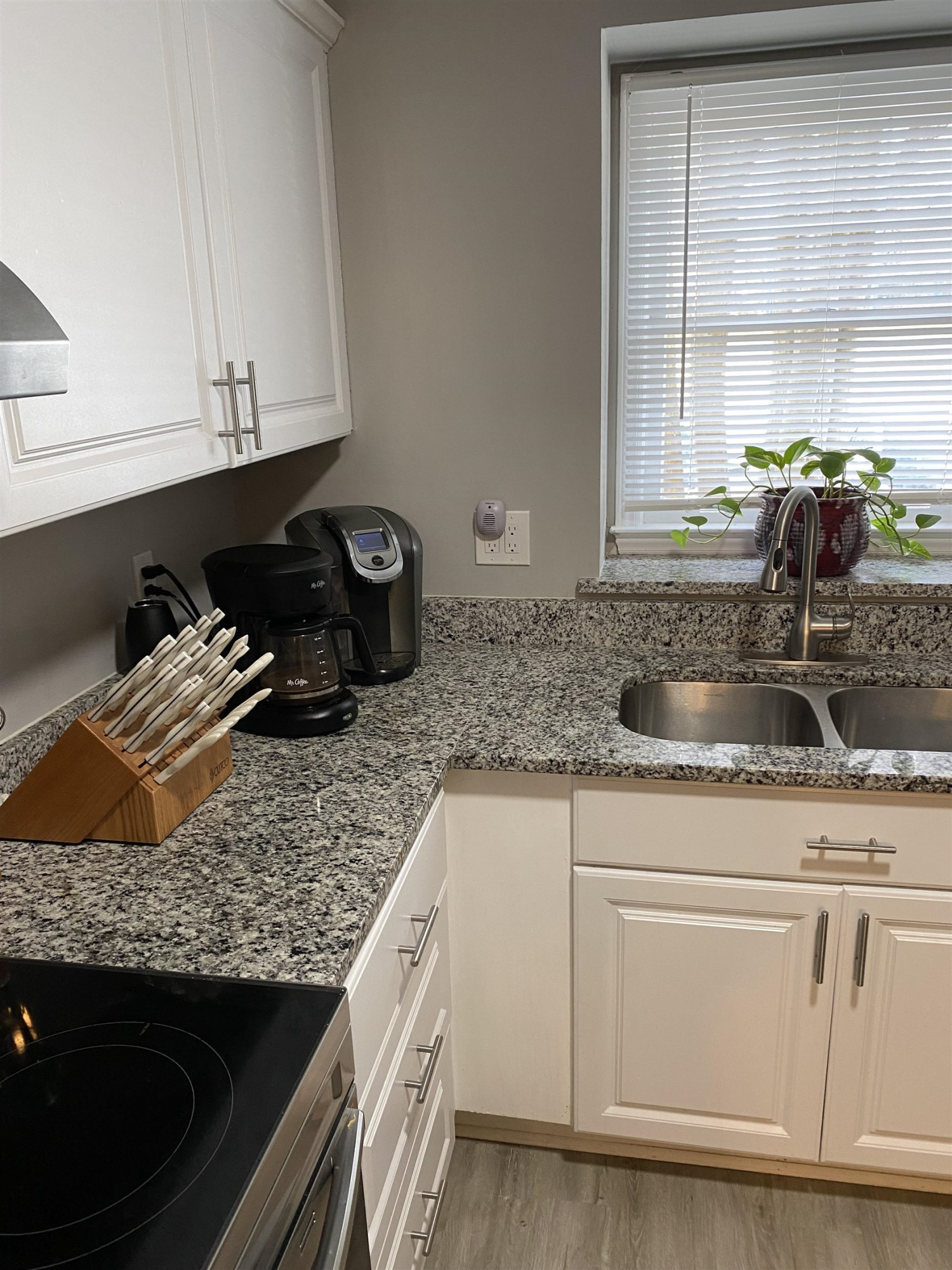 643 Springview Trail Garner, NC 27529 - Photo 15 of 34 a kitchen with granite countertop a sink a stove and cabinets