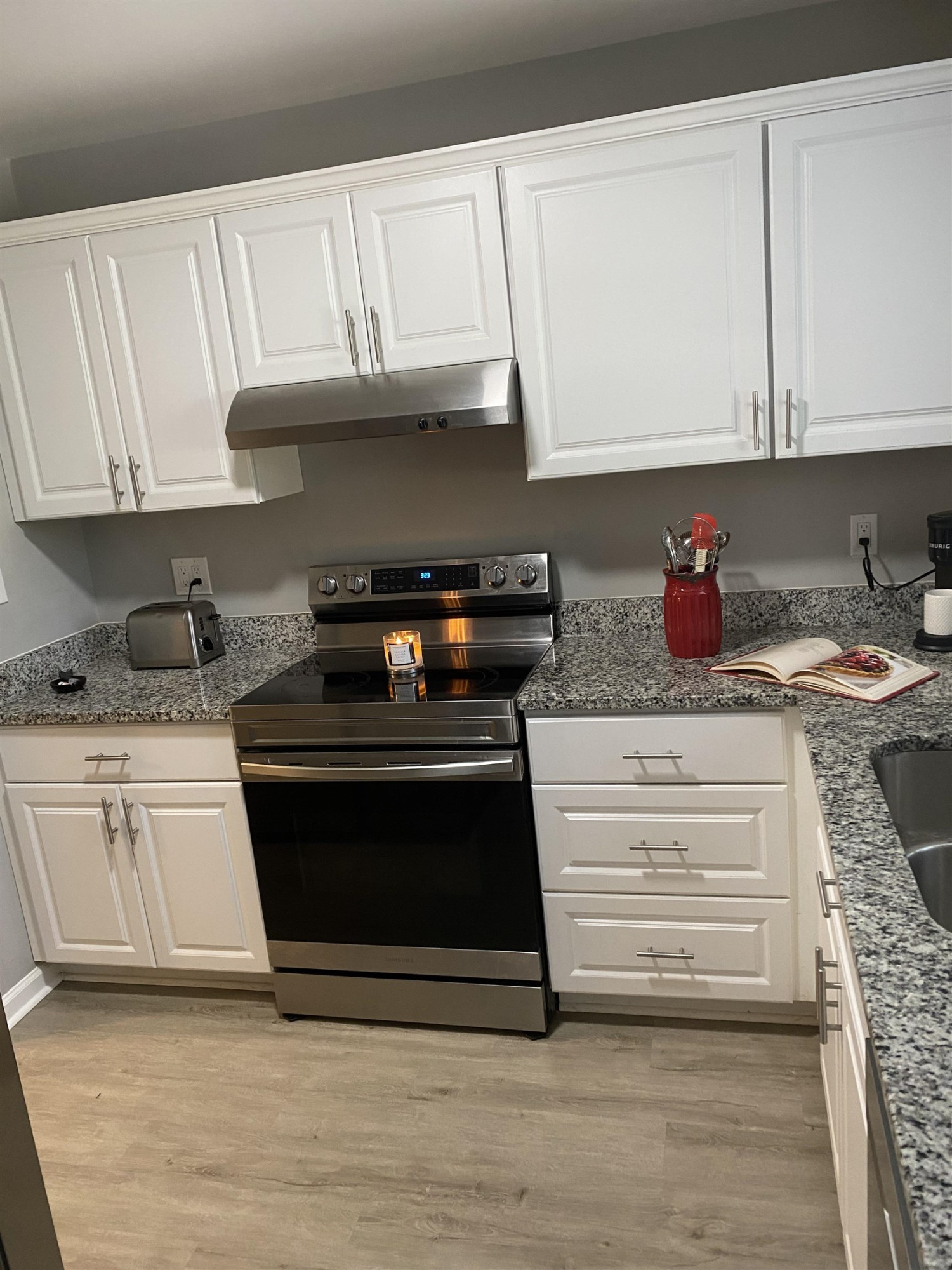 643 Springview Trail Garner, NC 27529 - Photo 18 of 34 a kitchen with granite countertop a stove and a cabinets