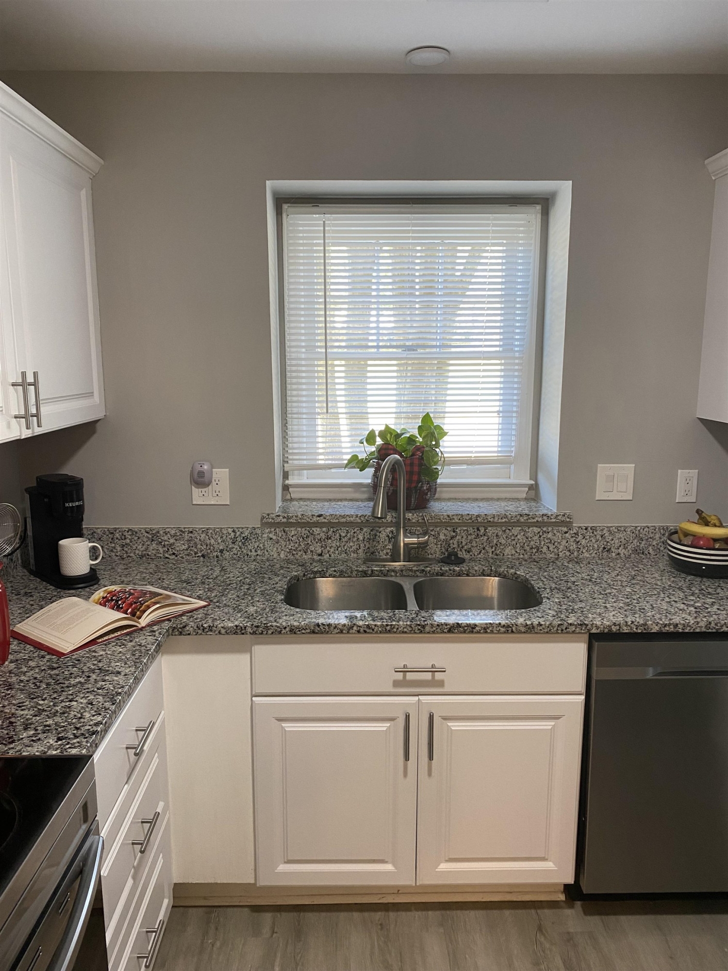 643 Springview Trail Garner, NC 27529 - Photo 19 of 34 a kitchen with granite countertop a sink and white cabinets