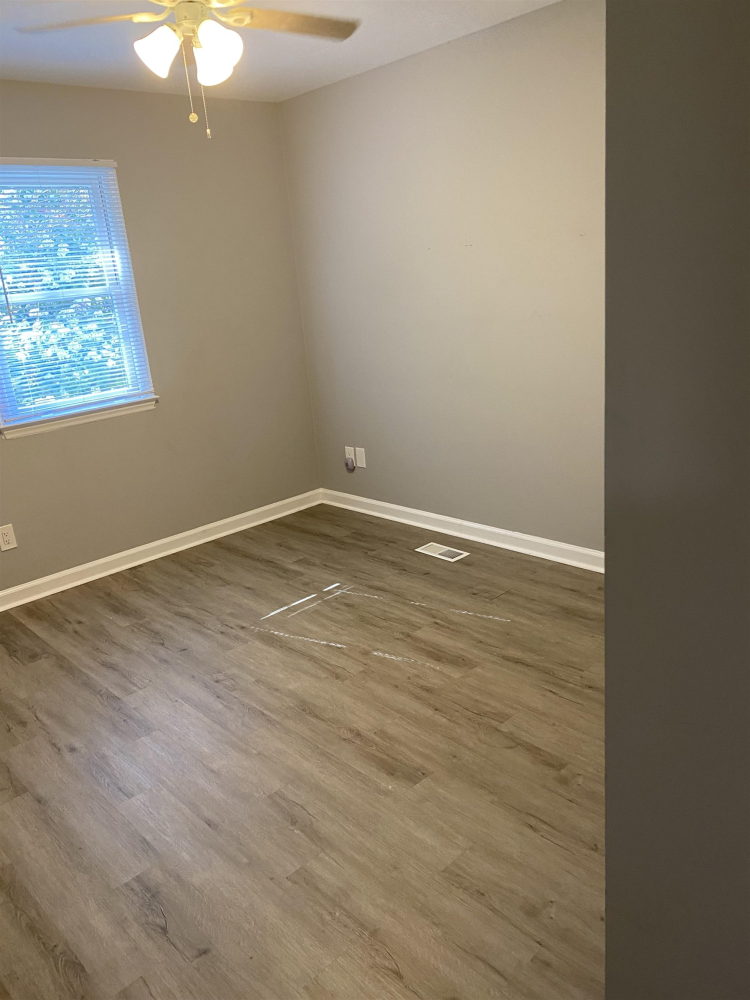 643 Springview Trail Garner, NC 27529 - Photo 33 of 34 a view of an empty room with wooden floor and a window