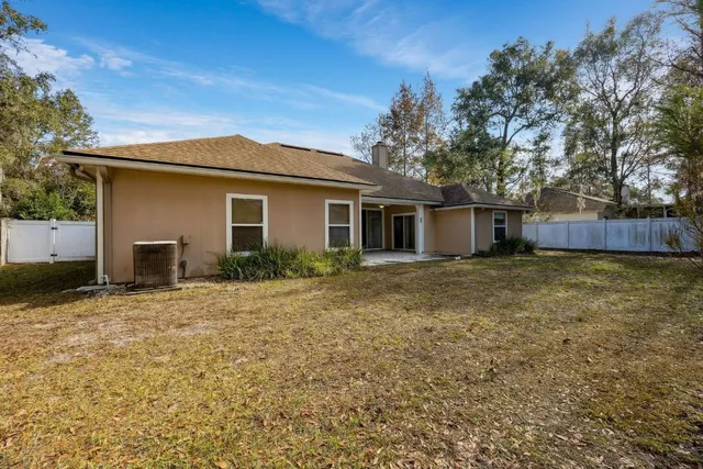 a front view of house with yard and trees