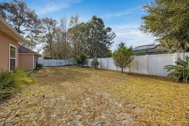 a backyard of a house with plants and trees