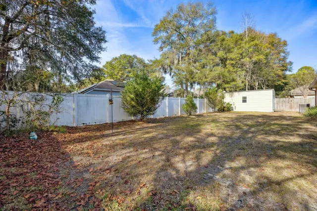 a view of backyard of house with green space