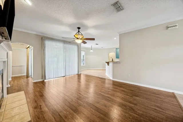a view of empty room with wooden floor