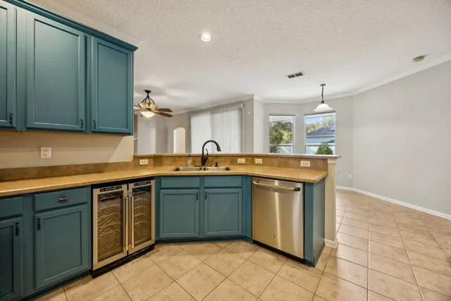 a kitchen with stainless steel appliances granite countertop a sink and a stove top oven