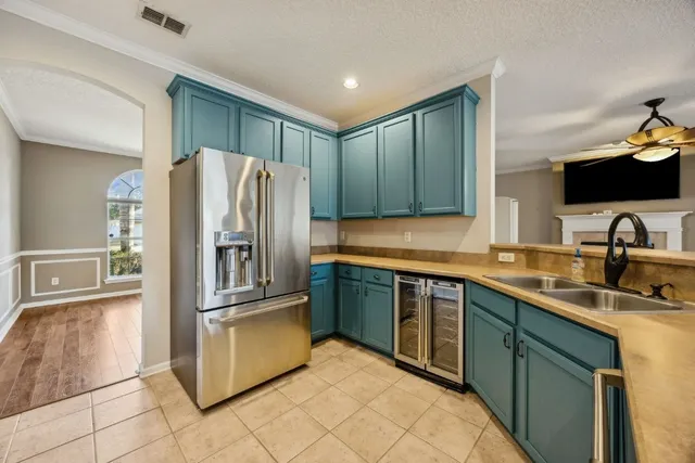 a kitchen with stainless steel appliances granite countertop a refrigerator and a sink
