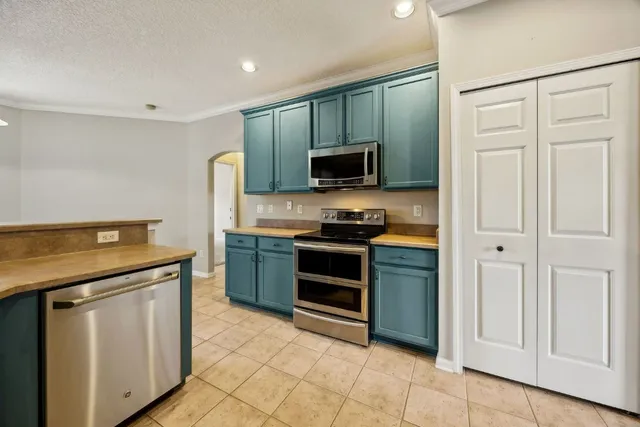 a kitchen with stainless steel appliances granite countertop a stove and a sink