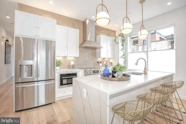 a kitchen with kitchen island granite countertop a table and chairs in it