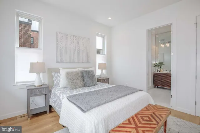a bedroom with a bed and a potted plant