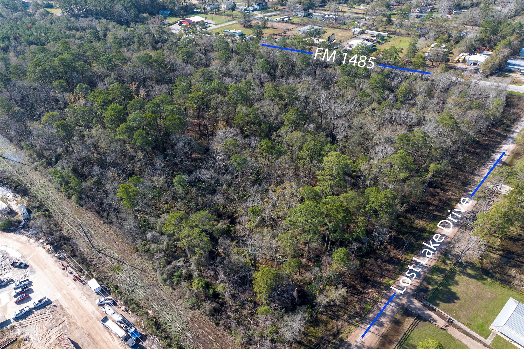 0 Fm 1485 Road New Caney, TX 77357 - Photo 6 of 13 a view of a forest with a street