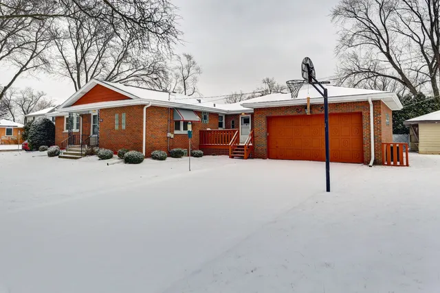 a view of a house with a snow in the yard