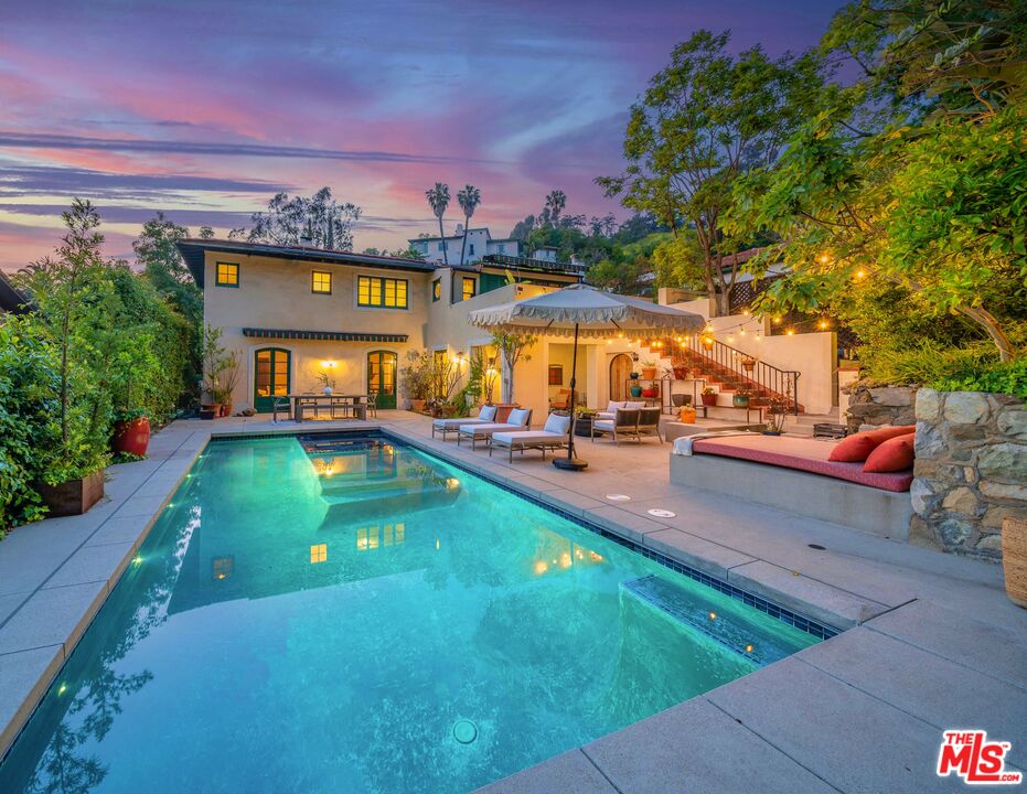 a view of a swimming pool with lounge chairs in patio