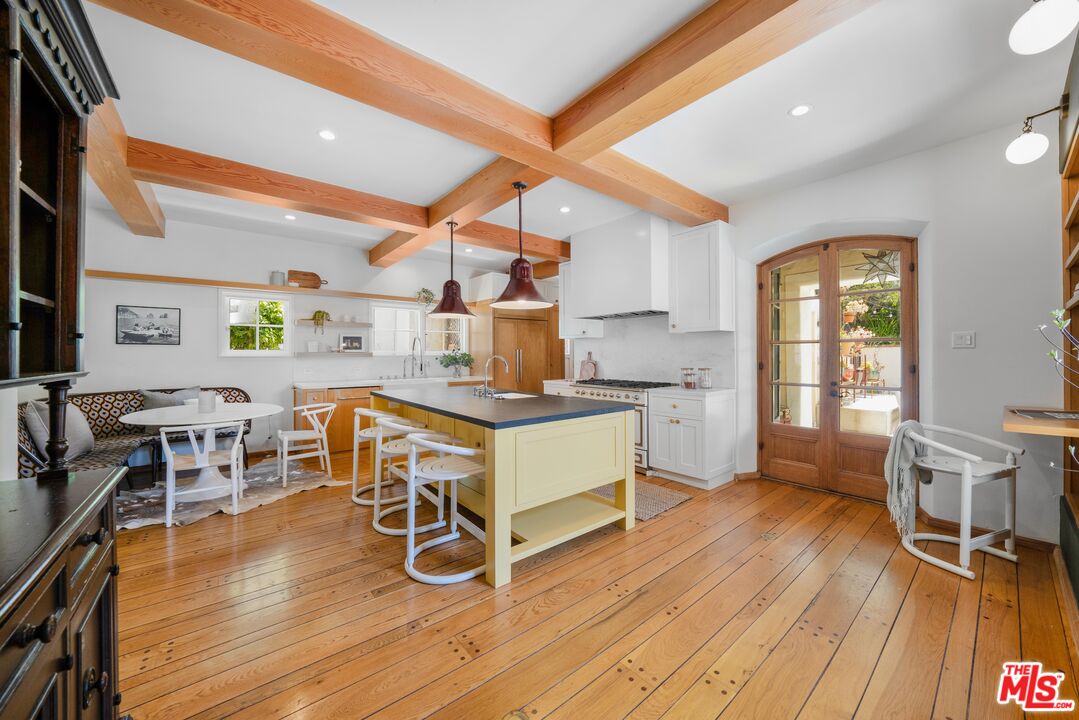 4124 Dundee Drive Los Angeles, CA 90027 - Photo 14 of 54 a room with wooden floors and white walls