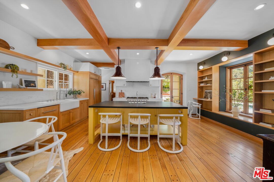 4124 Dundee Drive Los Angeles, CA 90027 - Photo 16 of 54 a dining hall with stainless steel appliances granite countertop a stove and wooden floor