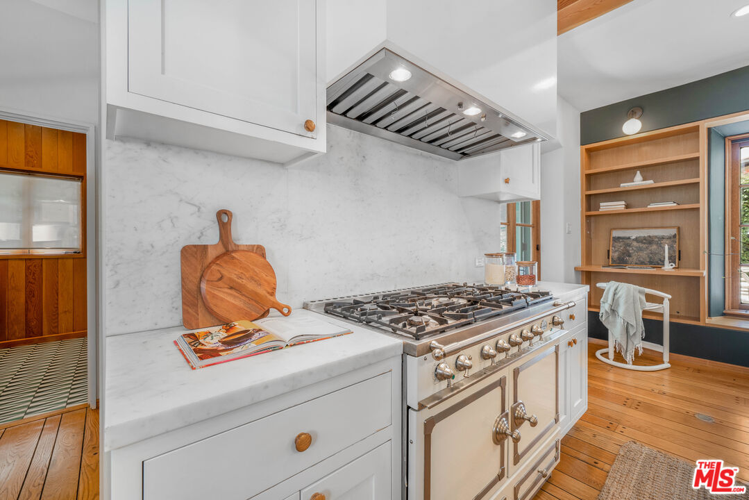 4124 Dundee Drive Los Angeles, CA 90027 - Photo 18 of 54 a kitchen with stainless steel appliances granite countertop a stove and a microwave