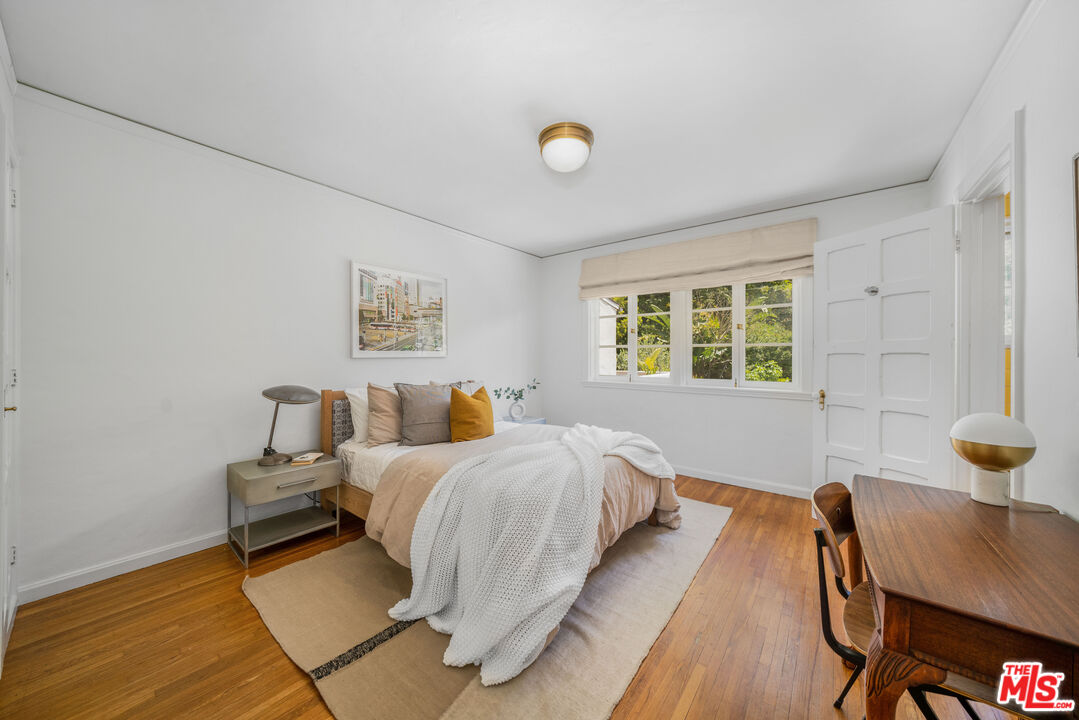4124 Dundee Drive Los Angeles, CA 90027 - Photo 26 of 54 a bedroom with bed and a window