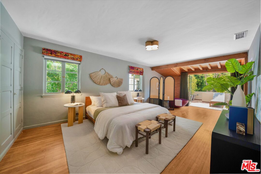 4124 Dundee Drive Los Angeles, CA 90027 - Photo 28 of 54 a bedroom with a bed and a large window