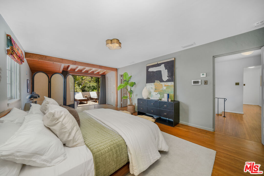 4124 Dundee Drive Los Angeles, CA 90027 - Photo 29 of 54 a bedroom with a bed and dresser with wooden floor