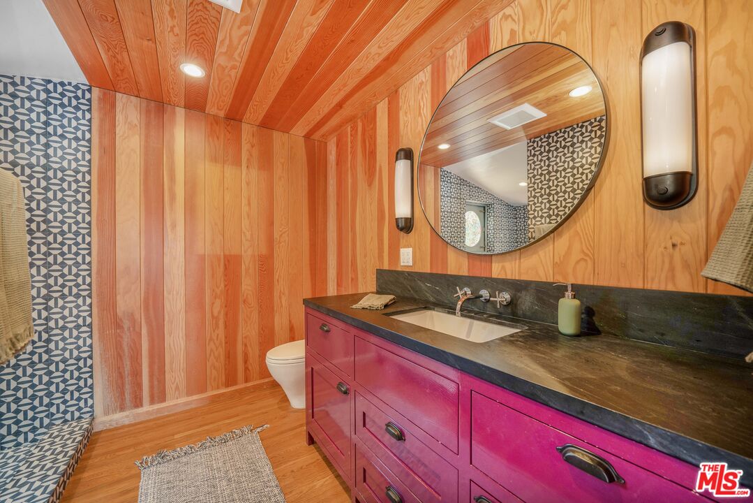 4124 Dundee Drive Los Angeles, CA 90027 - Photo 31 of 54 a bathroom with a granite countertop sink and a mirror