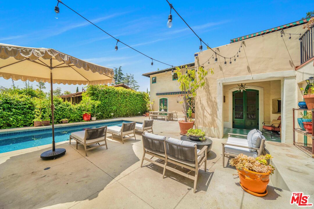 4124 Dundee Drive Los Angeles, CA 90027 - Photo 35 of 54 a view of a patio with a table and chairs under an umbrella