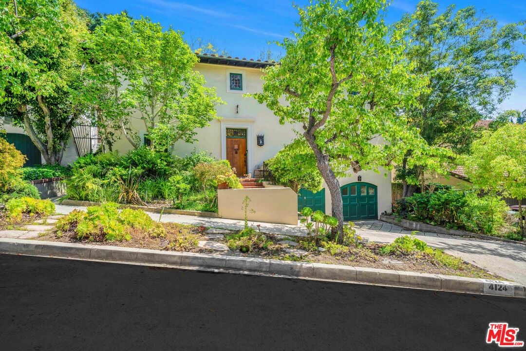 4124 Dundee Drive Los Angeles, CA 90027 - Photo 4 of 54 a front view of a house with a garden and yard