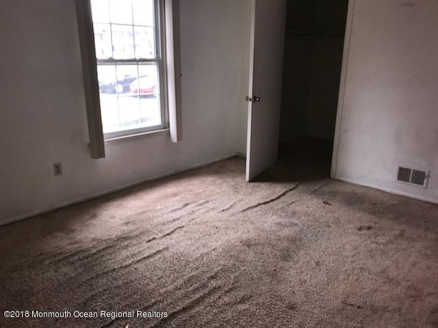 502 Harding Road Freehold, NJ 07728 - Photo 6 of 9 an empty room with windows