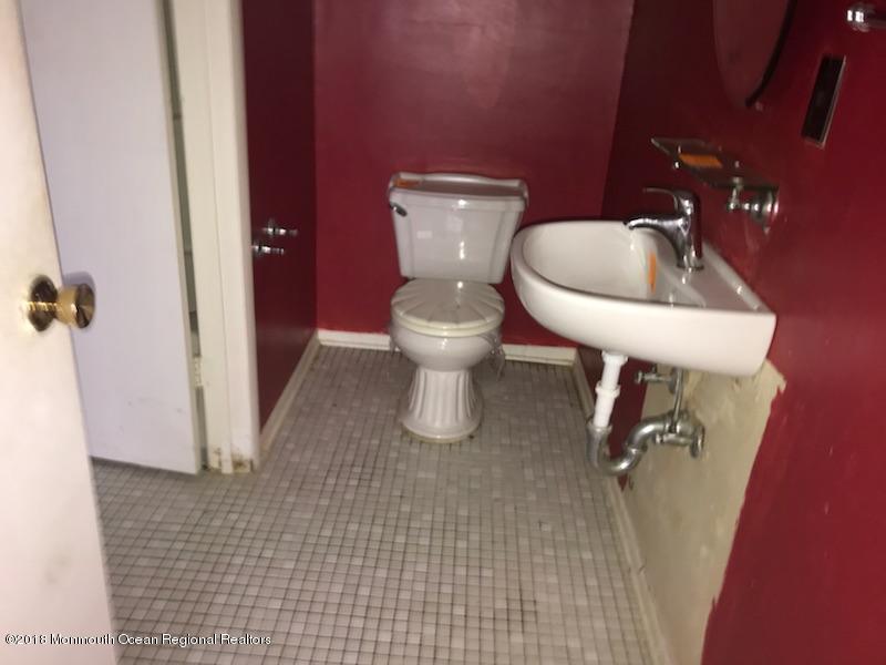 502 Harding Road Freehold, NJ 07728 - Photo 7 of 9 a bathroom with a toilet sink and mirror