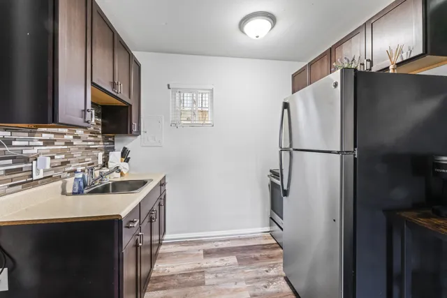 a kitchen with refrigerator a sink and dishwasher