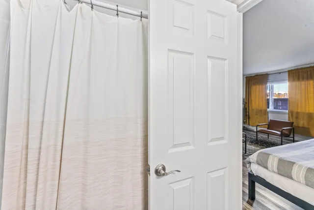 a view of a bedroom with table and chair