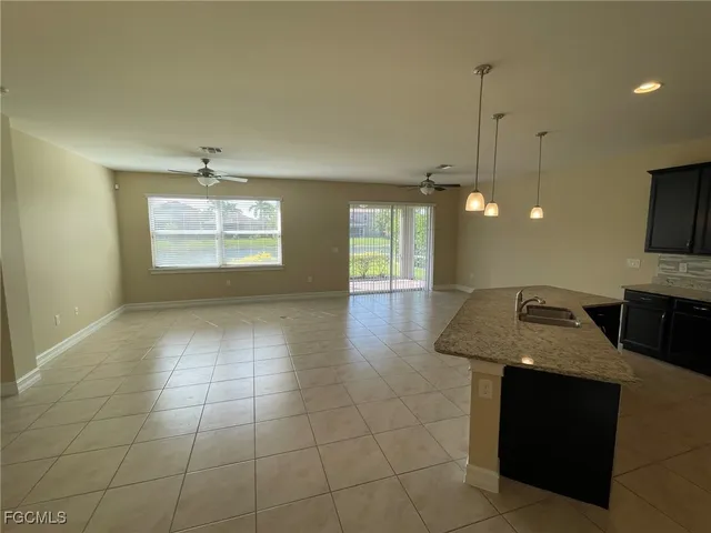 a view of a kitchen with a sink and chandelier