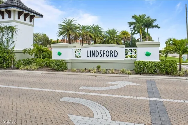 a sign on a street next to a building