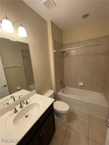 a bathroom with a sink a toilet and bathtub