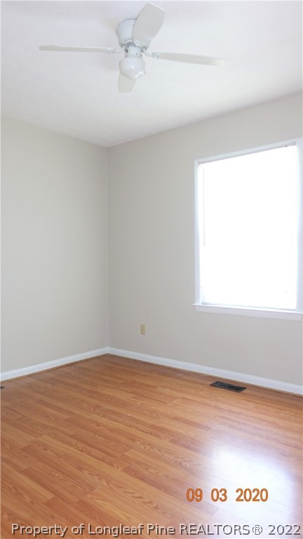 5856 Columbine Road Fayetteville, NC 28306 - Photo 13 of 25 an empty room with wooden floor and windows