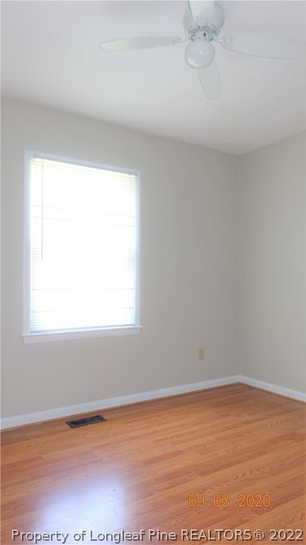 5856 Columbine Road Fayetteville, NC 28306 - Photo 14 of 25 an empty room with wooden floor and windows