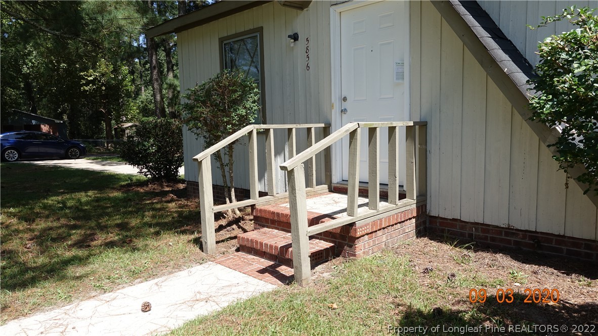 5856 Columbine Road Fayetteville, NC 28306 - Photo 3 of 25 a view of balcony with wooden floor and fence