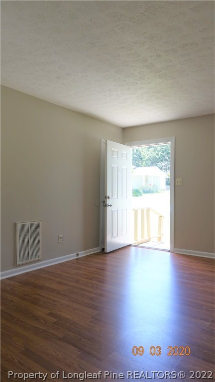 5856 Columbine Road Fayetteville, NC 28306 - Photo 5 of 25 a view of an empty room with wooden floor and a window