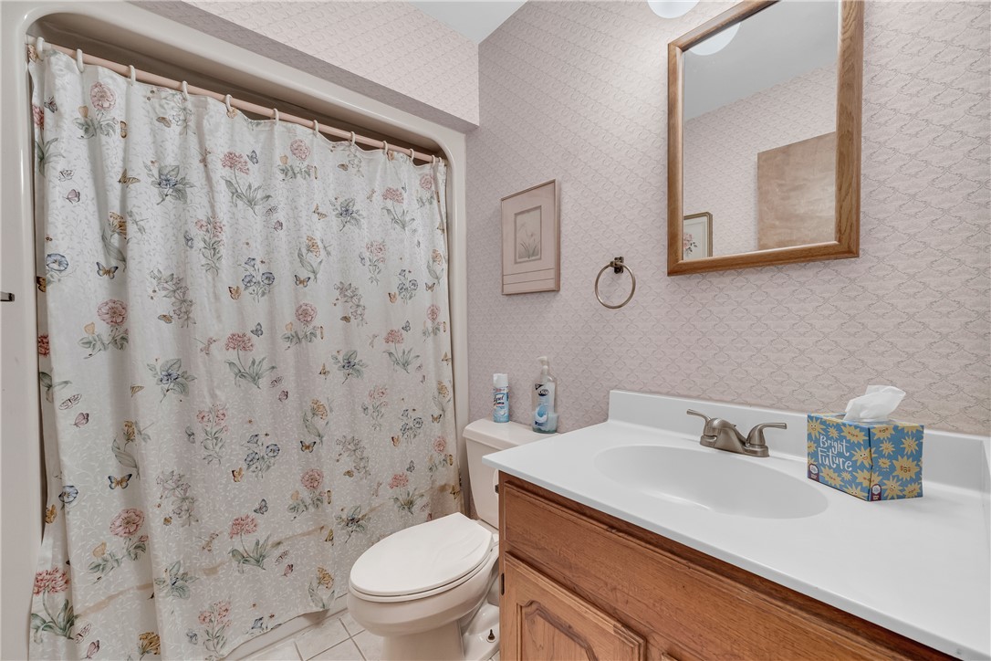 103 Colleton Court Clemson, SC 29631 - Photo 33 of 49 Patterned wallpaper accents this functional bathroom featuring a classic wooden vanity.