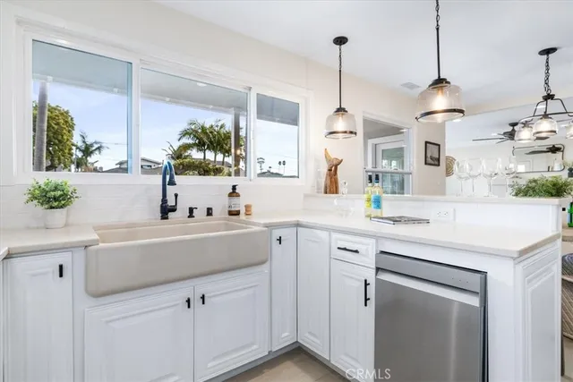 a kitchen with a sink and white cabinets