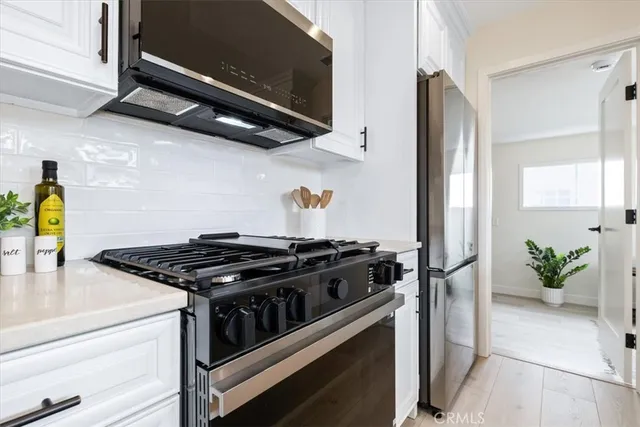 a kitchen with stainless steel appliances granite countertop a stove and a refrigerator