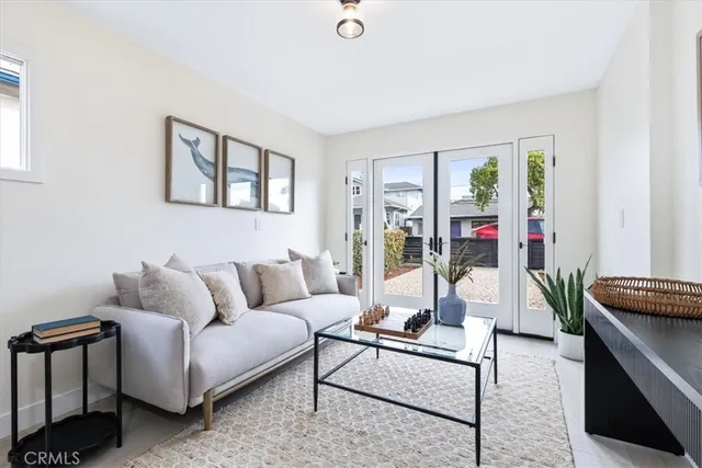 a living room with furniture plant and a window