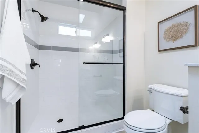 an empty room with wooden floor and ceiling fan