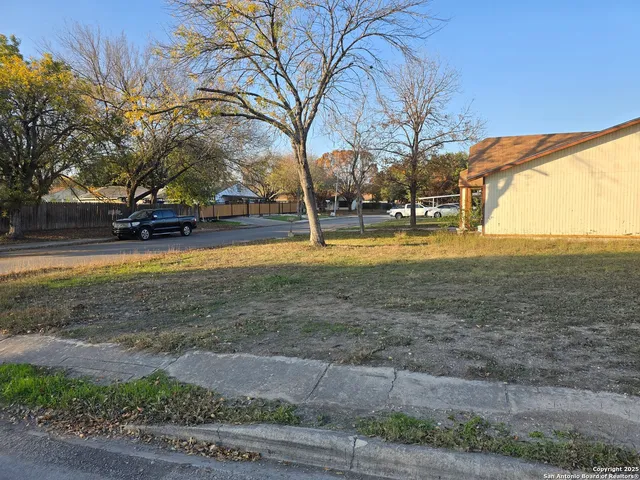 a view of yard with swimming pool and trees