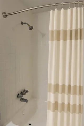 a bathroom with a shower and a shower curtain