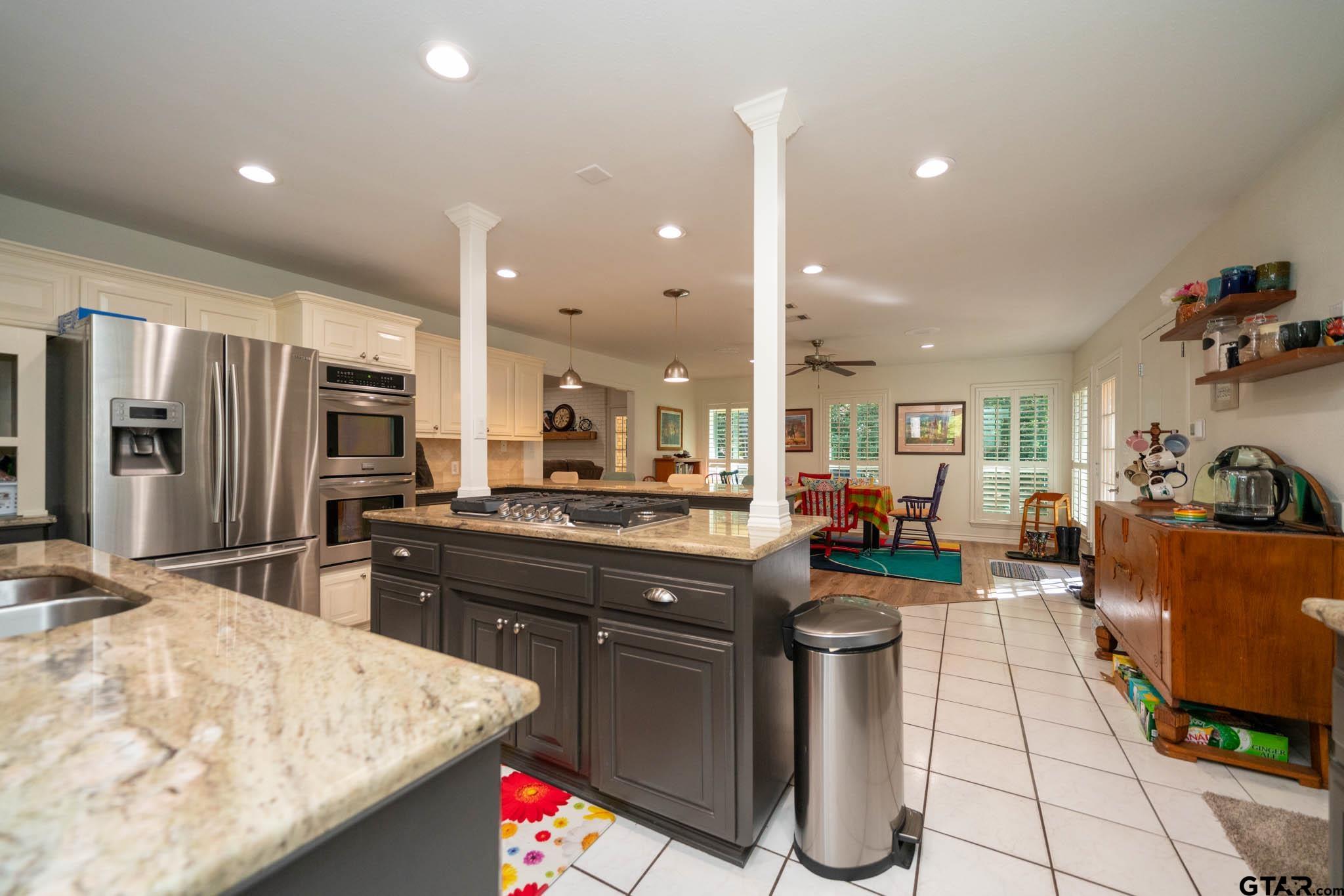 431 Gifford Street Rusk, TX 75785 - Photo 16 of 48 a kitchen with stainless steel appliances kitchen island granite countertop a sink stove and refrigerator