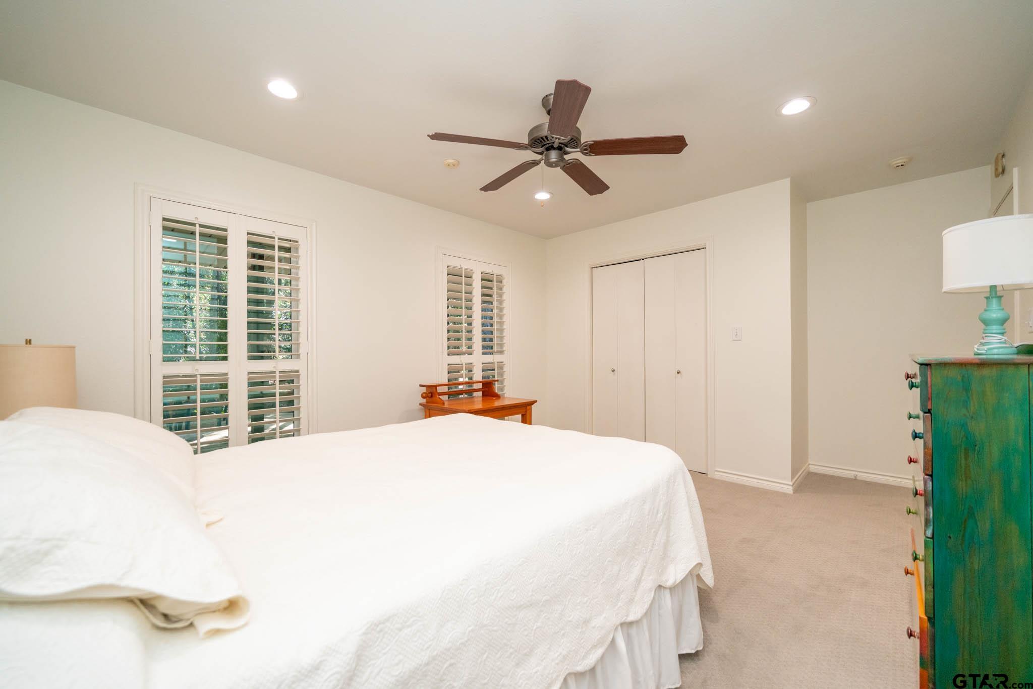 431 Gifford Street Rusk, TX 75785 - Photo 27 of 48 a bedroom with a large bed and a chandelier