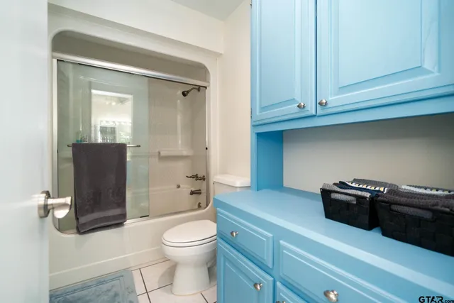 a spacious bedroom with a bed and a chandelier