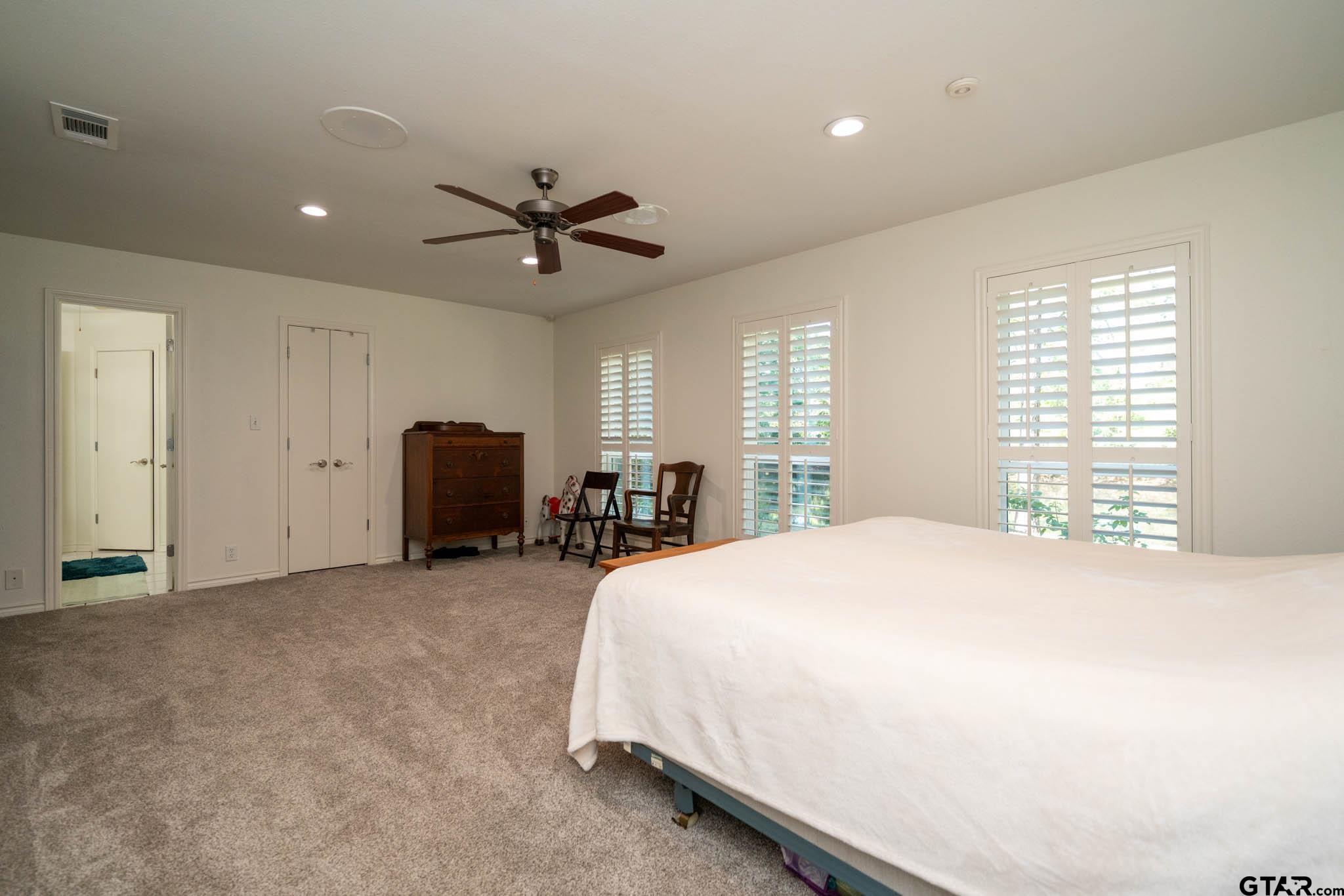 431 Gifford Street Rusk, TX 75785 - Photo 38 of 48 a spacious bedroom with a bed and a chandelier