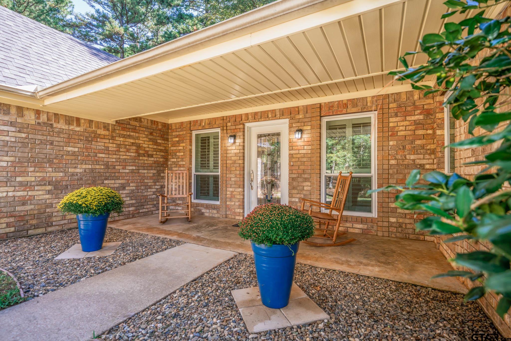 431 Gifford Street Rusk, TX 75785 - Photo 4 of 48 a potted plant sitting in front of a house with potted plants